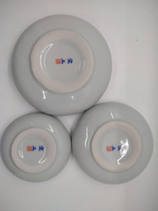 The undersides of a trio of Chinese ceramic bowls, all of different sizes
