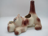 Side view of a ceramic planter shaped like a dog with a bee on its nose